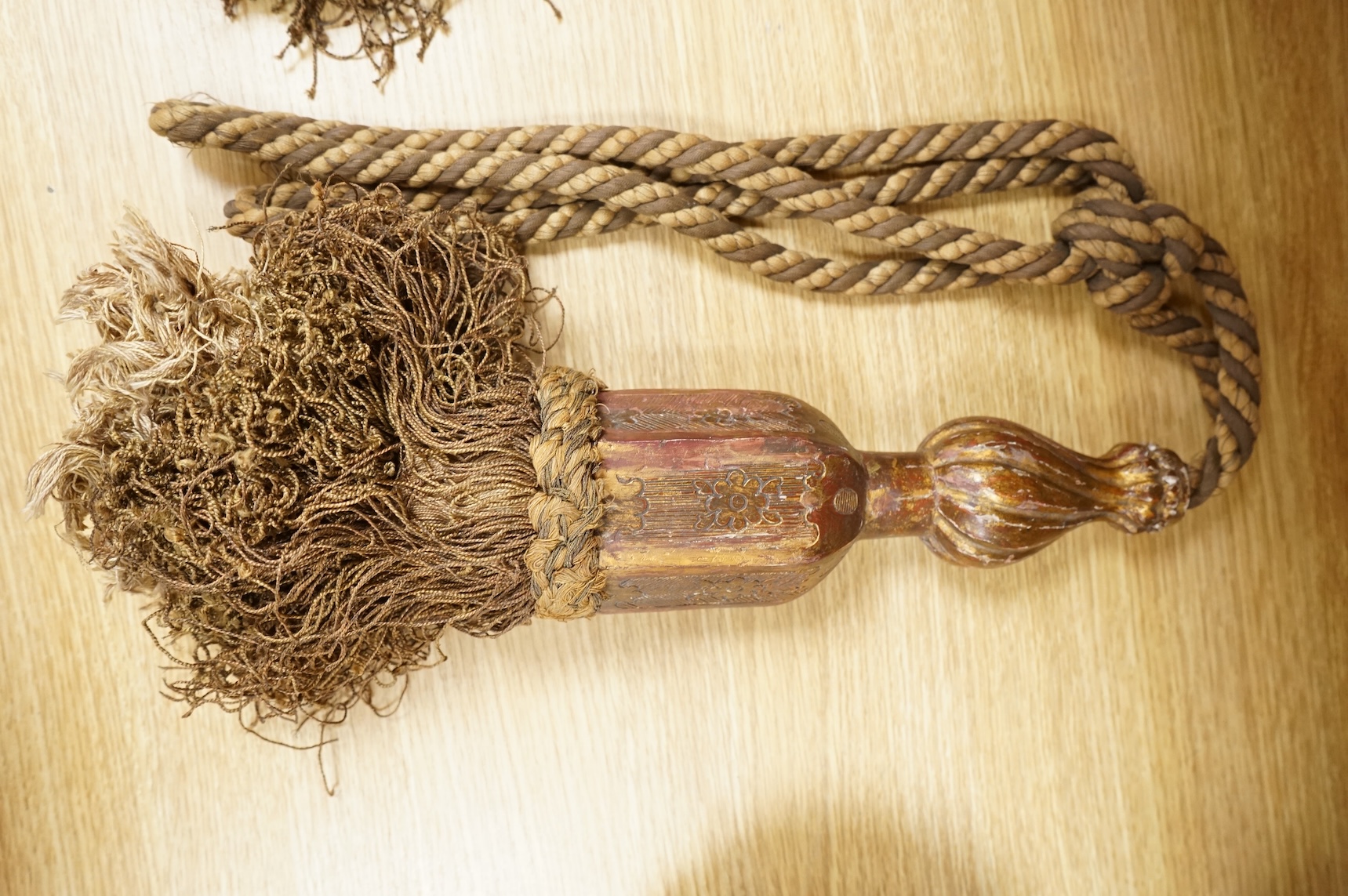 A pair of 19th century Venetian carved wood and tasseled tie-backs